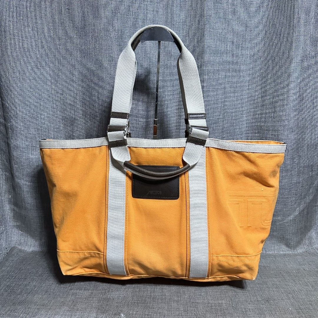 Tumi tote bag (Category: Luxury Bags & Wallets) located in Manila. Submitted by greyinfash06839 (Listing ID 1381456008, Image 1). Description: 🤍Item: Tumi tote bag 🤍Brand: Tumi 🤍Matirial: Nylon 🤍Quality: Original 🤍color: Orange 🤍Size: Large 🤍Dimension. H: 14 L: 17 W: 7 🤍Sex: Unisex 🤍Issue: Sign of use 🤍Condition Rate: 9/10 🤍Other info:.