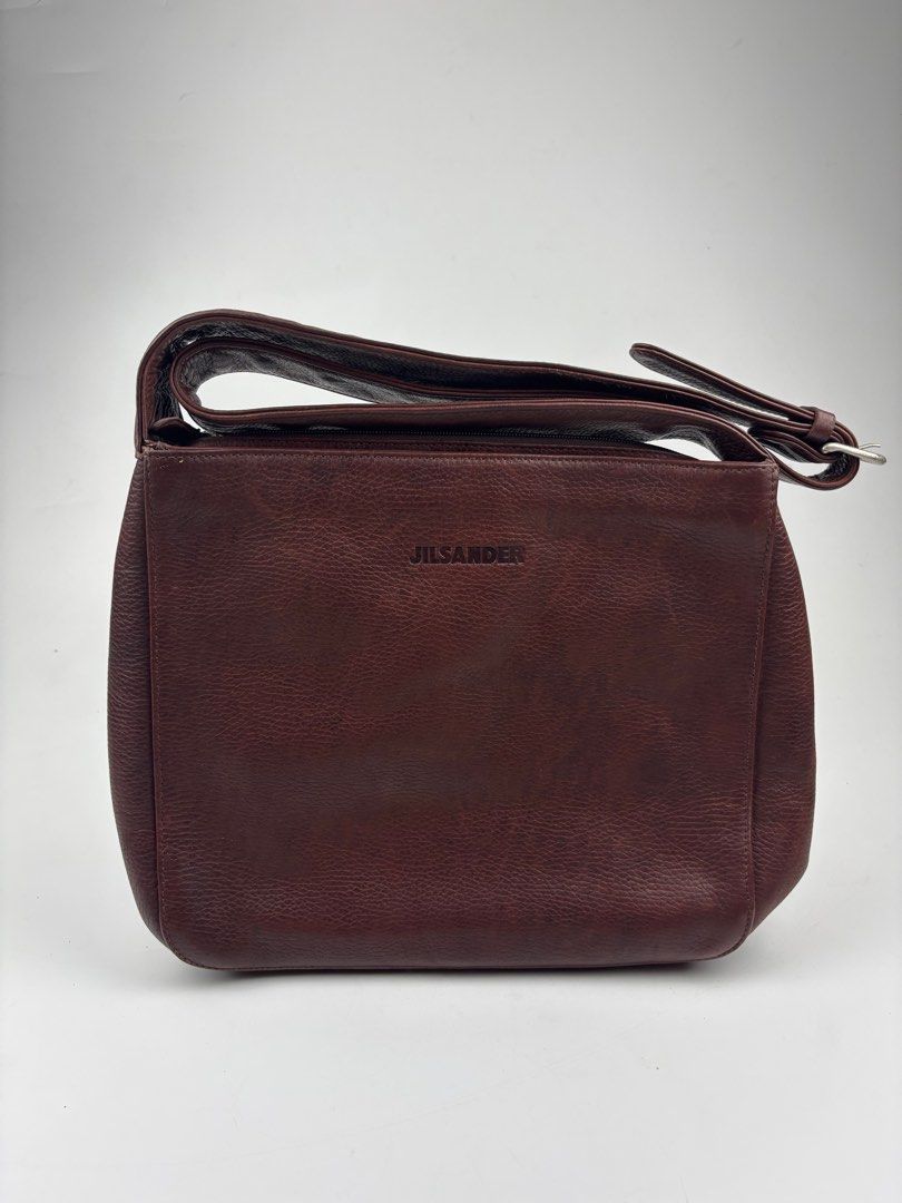 JIL SANDER Archive Leather Crossbody Bag (Category: Luxury Bags & Wallets) located in Makati City. Submitted by ragrepository (Listing ID 1381646147, Image 1). Description: JIL SANDER Archive Leather Crossbody Bag Height- 10.5” Width- 11.5” Depth-2.5” Strap drop-18.5” (adjustable) Condition- 9/10 Flaw- Minimal wear, Leather Patina .