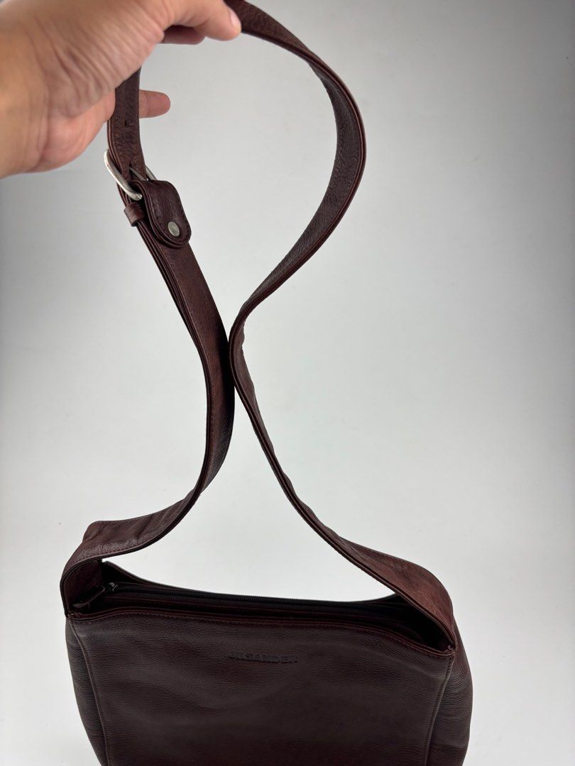 JIL SANDER Archive Leather Crossbody Bag (Category: Luxury Bags & Wallets) located in Makati City. Submitted by ragrepository (Listing ID 1381646147, Image 2). Description: JIL SANDER Archive Leather Crossbody Bag Height- 10.5” Width- 11.5” Depth-2.5” Strap drop-18.5” (adjustable) Condition- 9/10 Flaw- Minimal wear, Leather Patina .