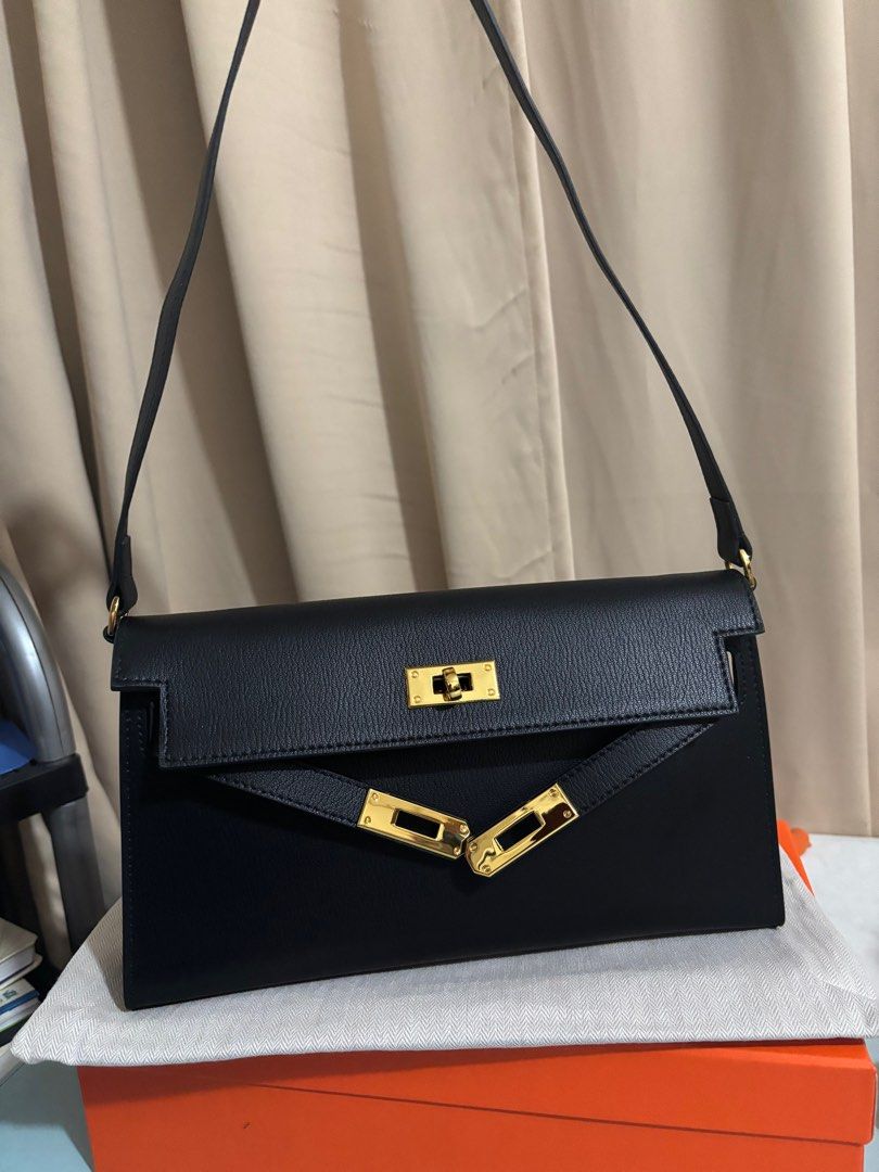 Kelly elan in Noir (Category: Luxury Bags & Wallets) located in Paranaque City. Submitted by declutterqueeen (Listing ID 1381628538, Image 1). Description: Kelly elan in black noir No brand or logo Comes with box, dust bag, shoulder strap and crossbody strap Made of genuine leather Flaw: very small sticker residue inside (see last photo), does not affect the bag function Barely used Rfs: decluttering Slightly nego.