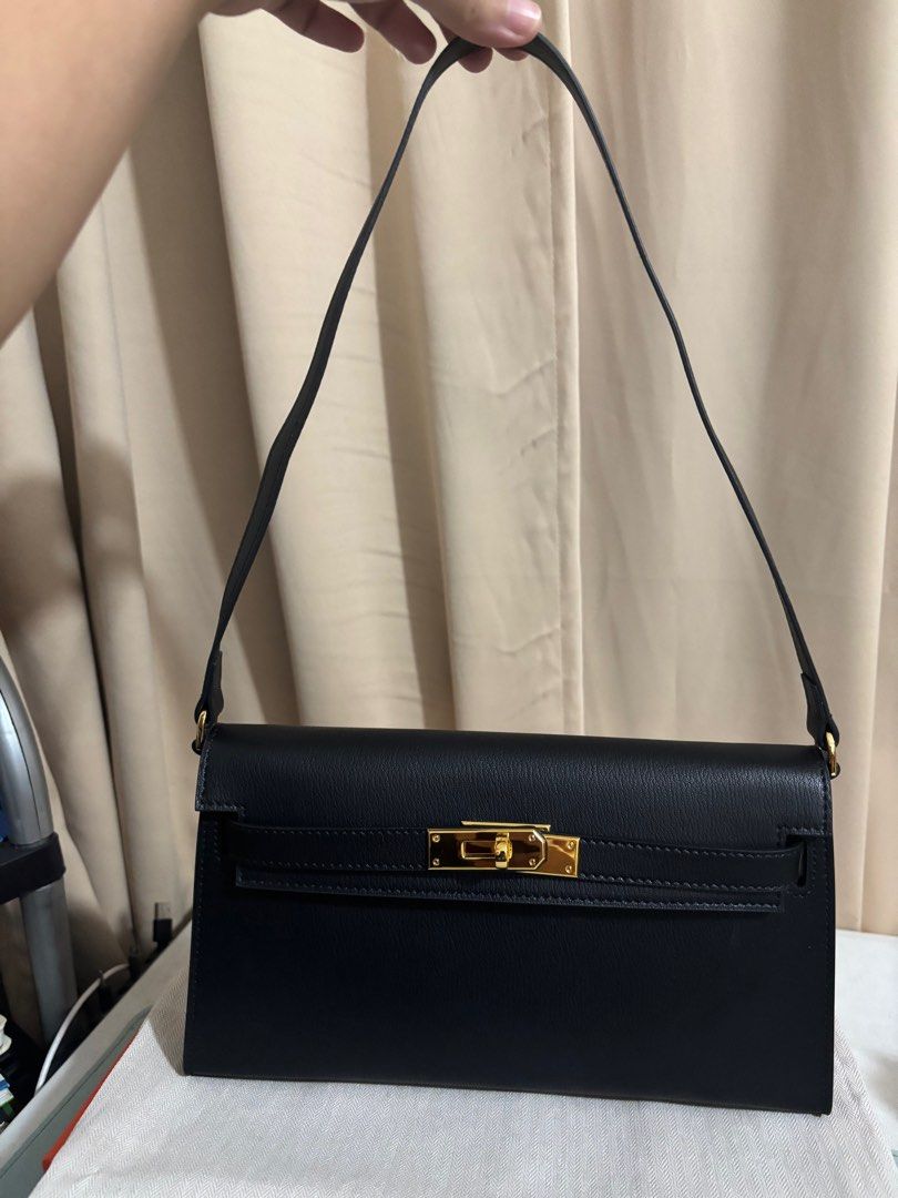 Kelly elan in Noir (Category: Luxury Bags & Wallets) located in Paranaque City. Submitted by declutterqueeen (Listing ID 1381628538, Image 2). Description: Kelly elan in black noir No brand or logo Comes with box, dust bag, shoulder strap and crossbody strap Made of genuine leather Flaw: very small sticker residue inside (see last photo), does not affect the bag function Barely used Rfs: decluttering Slightly nego.