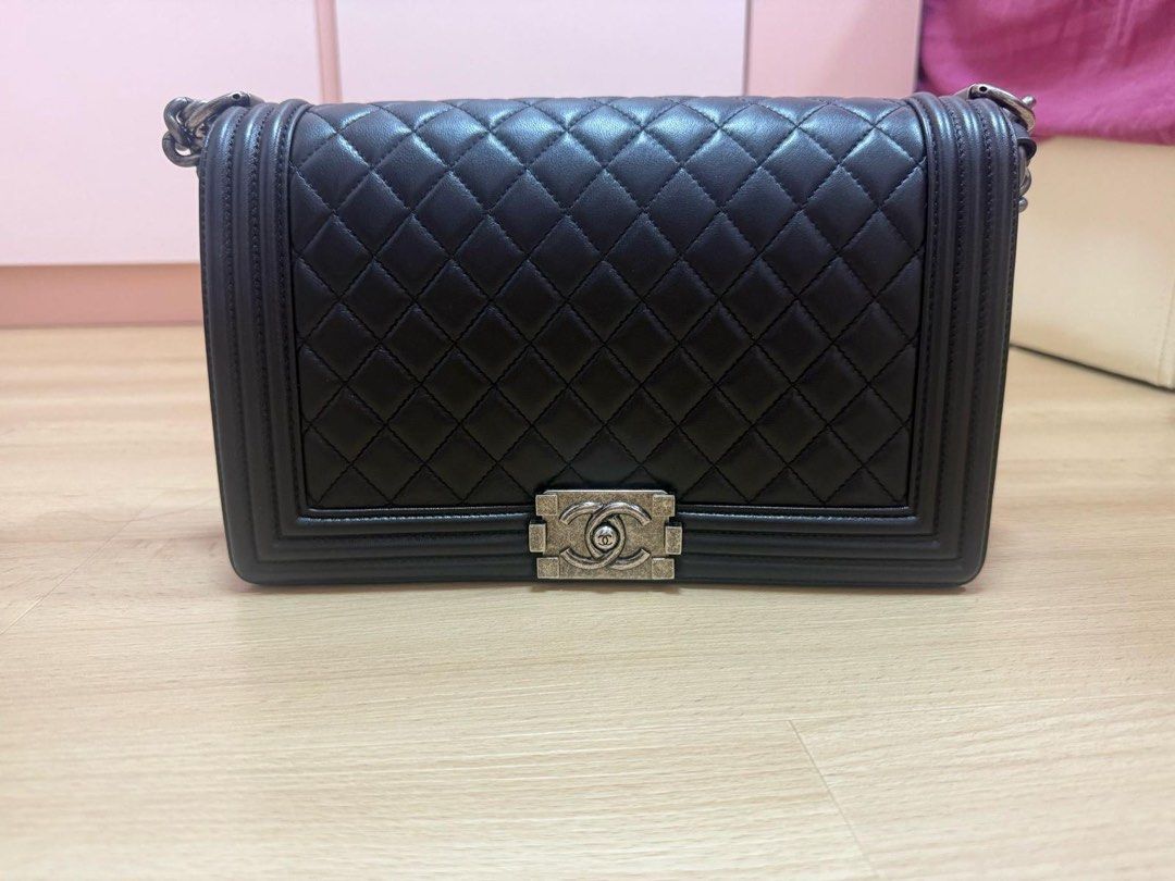 Chanel Boy New Medium - 28cm Quilted Lambskin Black Ruthenium Silver Hardware Series 21 (Category: Bags & Wallets) located in Singapore. Submitted by kengb (Listing ID 1378194802, Image 1). Description: Used Chanel Boy 28cm bag. Refer to title for the model. Come with certificate, dust bag and box (some flaw on the corner). PM to make arrangement to view the bag..