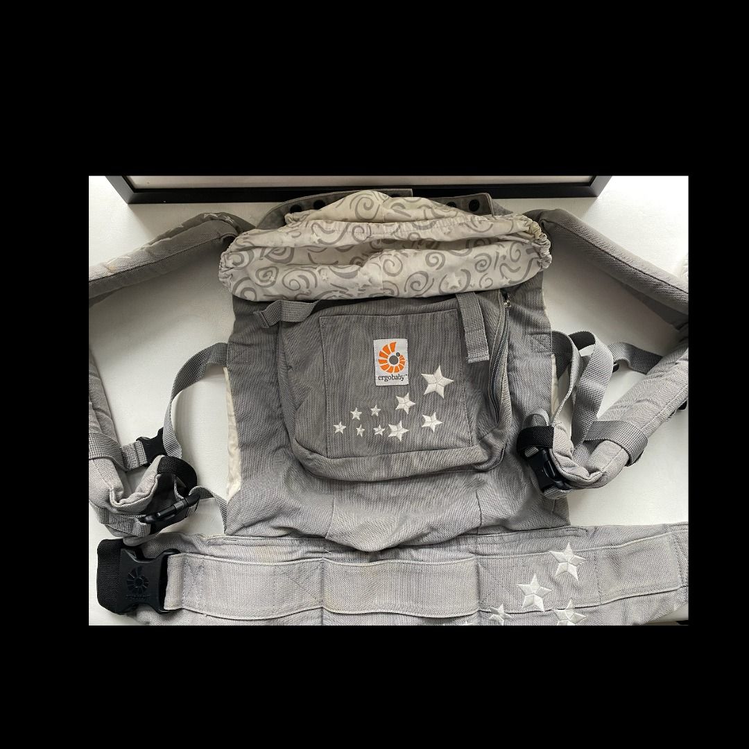 Ergobaby Baby Carrier - Grey with Stars (Category: Carriers & Slings) located in Singapore. Submitted by merontanon0311 (Listing ID 1378164802, Image 2). Description: Comes with cushion and cover - Gently used Ergobaby baby carrier in excellent condition. Features a stylish grey design with star accents. Includes a detachable head support. Comfortable and ergonomic design for both parent and baby. Perfect for carrying your little one safely and s