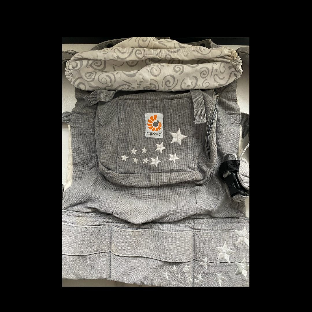 Ergobaby Baby Carrier - Grey with Stars (Category: Carriers & Slings) located in Singapore. Submitted by merontanon0311 (Listing ID 1378164802, Image 1). Description: Comes with cushion and cover - Gently used Ergobaby baby carrier in excellent condition. Features a stylish grey design with star accents. Includes a detachable head support. Comfortable and ergonomic design for both parent and baby. Perfect for carrying your little one safely and s