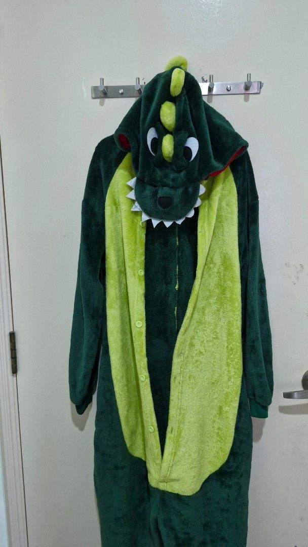 Green Dinosaur costume onsie (Category: Babies & Kids Fashion) located in Singapore. Submitted by rosemary5 (Listing ID 1378327188, Image 2). Description: - Green dinosaur onesie - Features a hood with eyes, teeth, and spines - Soft material - Yellow belly - Zipper closure - Perfect for lounging or costume parties - length-130cm - 130cm length .