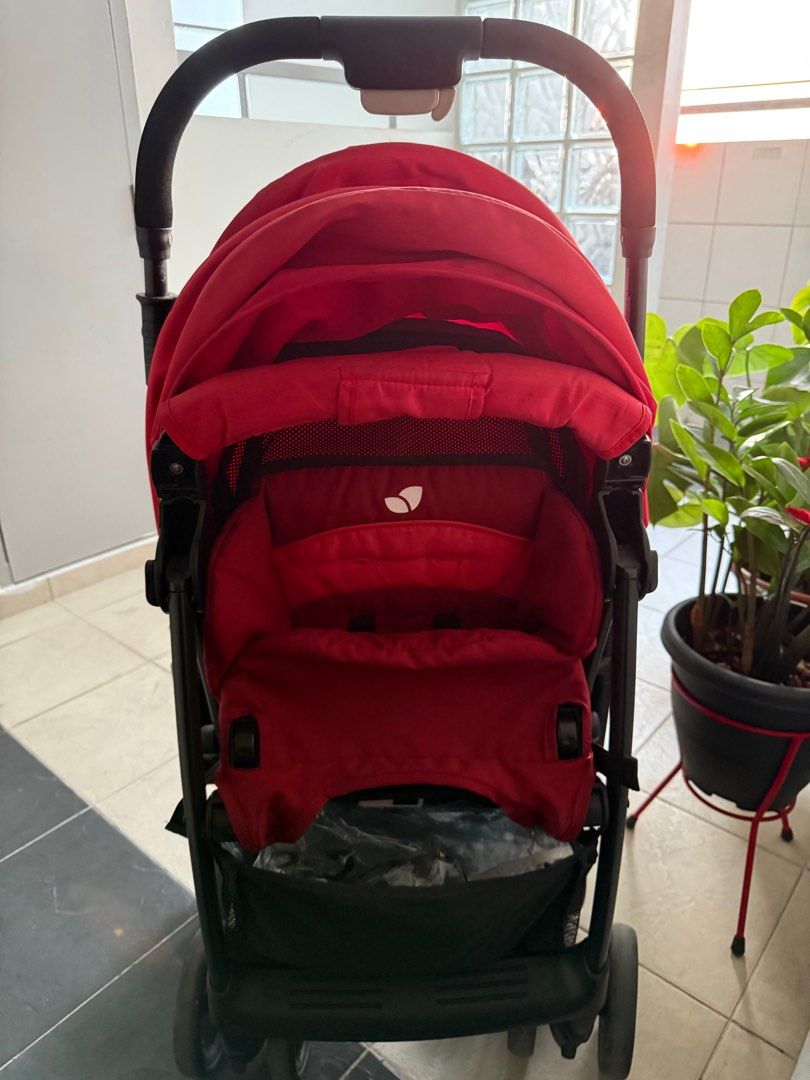 Joie Stroller - Red (Category: Strollers) located in Singapore. Submitted by joey-tan (Listing ID 1378153882, Image 1). Description: Red Joie stroller in good condition. Features a sun canopy and storage basket. Wheels appear to be in good shape. Perfect for everyday use. Please see photos for details..