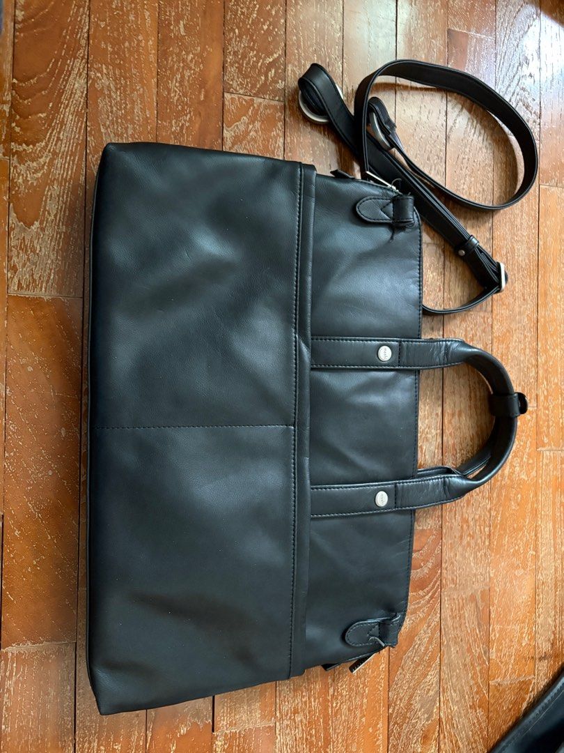 Moshi Treya Briefcase - Jet Black (Category: Briefcases) located in Singapore. Submitted by stuffcool (Listing ID 1378153752, Image 3). Description: Stylish Moshi Treya Briefcase in Jet Black. Features a modern, yet classic look with a premium vegan leather finish. Perfect for professionals on the go. Includes multiple compartments for organization. Brand new, never used..