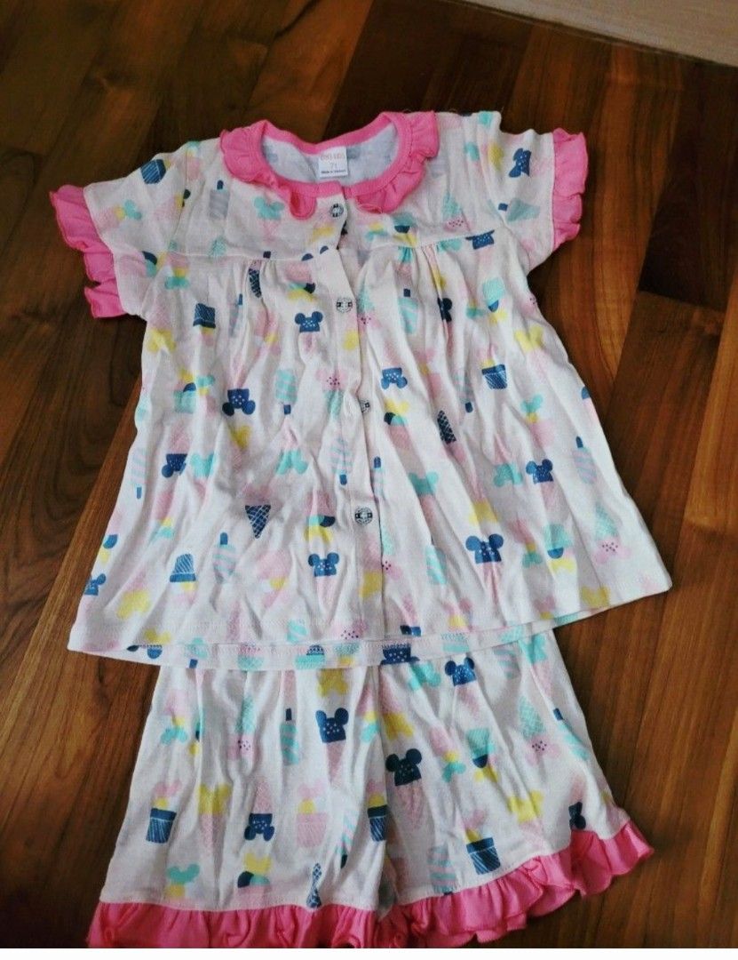 New Kids Set with Mickey Mouse Print size 7T (Category: Babies & Kids Fashion) located in Singapore. Submitted by goodyseally (Listing ID 1378217082, Image 1). Description: - Brand new kids pajama set - Features a cute Mickey Mouse print - Includes a short-sleeved top with a ruffled collar - Matching shorts included - Comes in original packaging.