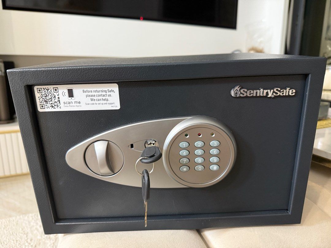 SentrySafe Electronic Safe with Key (Category: Safe) located in Singapore. Submitted by mugened (Listing ID 1378279513, Image 2). Description: This SentrySafe electronic safe is in excellent condition. It comes with a key and a digital keypad for easy access. Perfect for securing valuables at home or in the office. The safe is sturdy and reliable. 35cm x 25cm x 22cm.