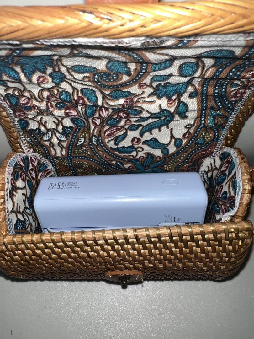 Small Wallet Rattan Bag from Bali (Category: Cross-body Bags) located in Quezon City. Submitted by rinea (Listing ID 1378195866, Image 3). Description: - selling a small wallet rattan bag purchased in Bali - unique design, crossbody type - never used outside, only tried to put things in - powerbank placed for size reference only - can fit a 119 x 72 x 31.8 mm powerbank and other essentials; can't fit an iphone 13 - send a msg if interested! thank