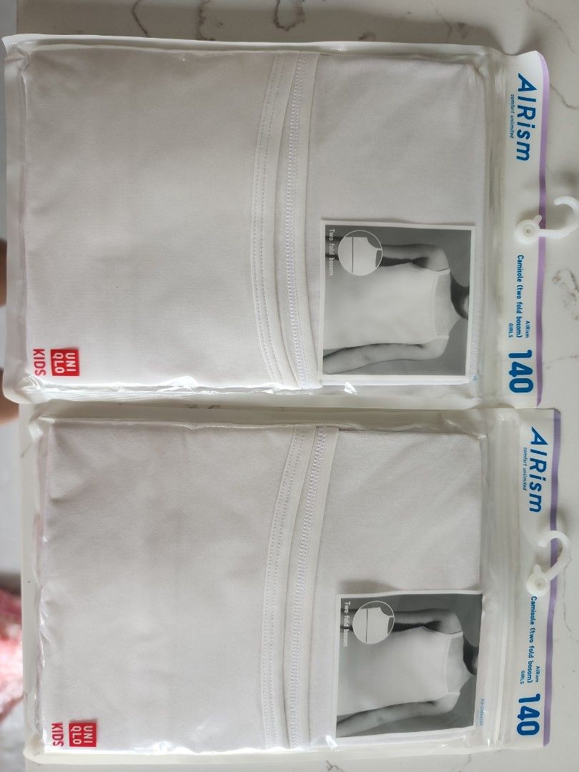Uniqlo Airism Kids Tank Top - Size 140 (Category: Babies & Kids Fashion) located in Singapore. Submitted by fatshaman (Listing ID 1378233928, Image 1). Description: - New, unopened Uniqlo Airism Kids tank tops - Available in white and black - Size 140 - Perfect for layering or wearing alone - Comfortable and breathable material - Ideal for everyday wear.