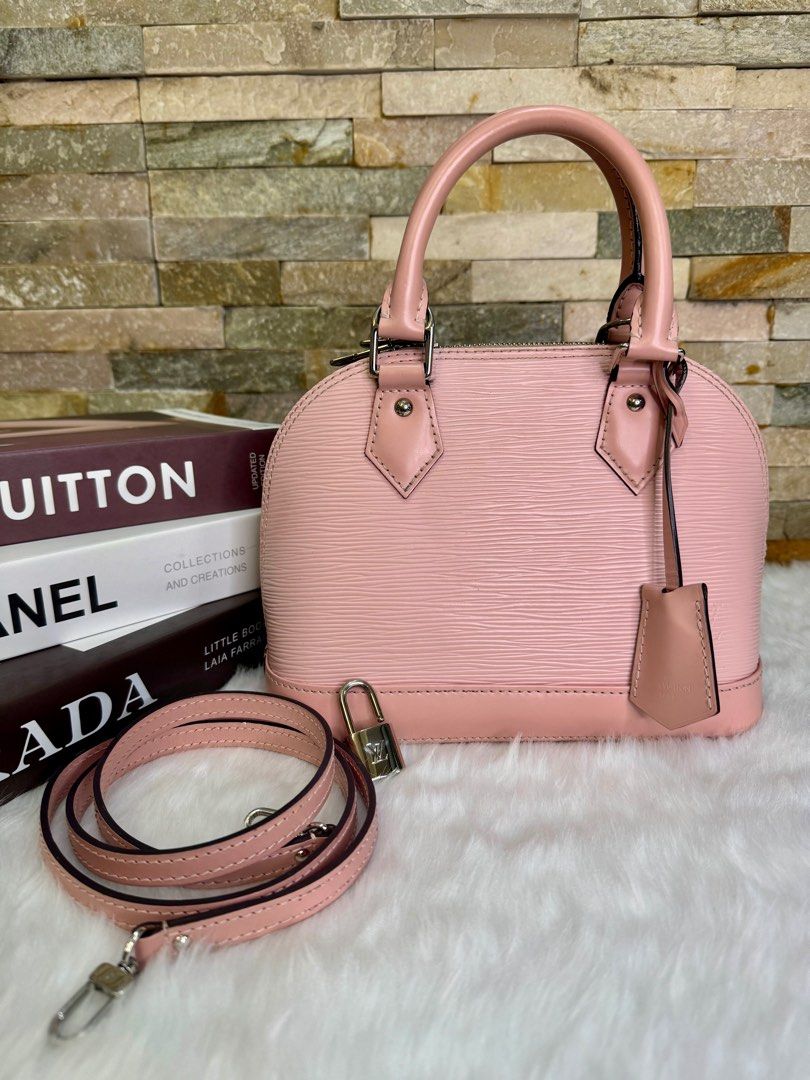 LV Epi Alma BB (Category: Luxury Bags & Wallets) located in Taguig. Submitted by angelbellaclaire (Listing ID 1381720529, Image 2). Description: “MINERS GONNA LOVE THIS 💕 Louis Vuitton Alma BB Epi Baby Pink (9.5/10) – Scratch-resistant Epi leather – With long strap for crossbody – Compact but spacious – Perfect for daily use or special dates!” 📐 Size: 9.8 x 7.5 x 4.7 inches 📦 Comes complete with lock, key, clochette & dustbag ‼️ VERY RARE COLO