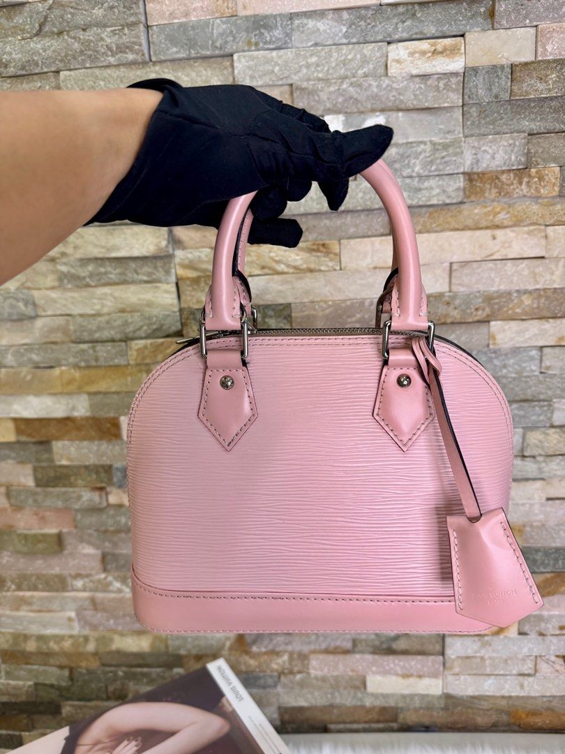 LV Epi Alma BB (Category: Luxury Bags & Wallets) located in Taguig. Submitted by angelbellaclaire (Listing ID 1381720529, Image 3). Description: “MINERS GONNA LOVE THIS 💕 Louis Vuitton Alma BB Epi Baby Pink (9.5/10) – Scratch-resistant Epi leather – With long strap for crossbody – Compact but spacious – Perfect for daily use or special dates!” 📐 Size: 9.8 x 7.5 x 4.7 inches 📦 Comes complete with lock, key, clochette & dustbag ‼️ VERY RARE COLO