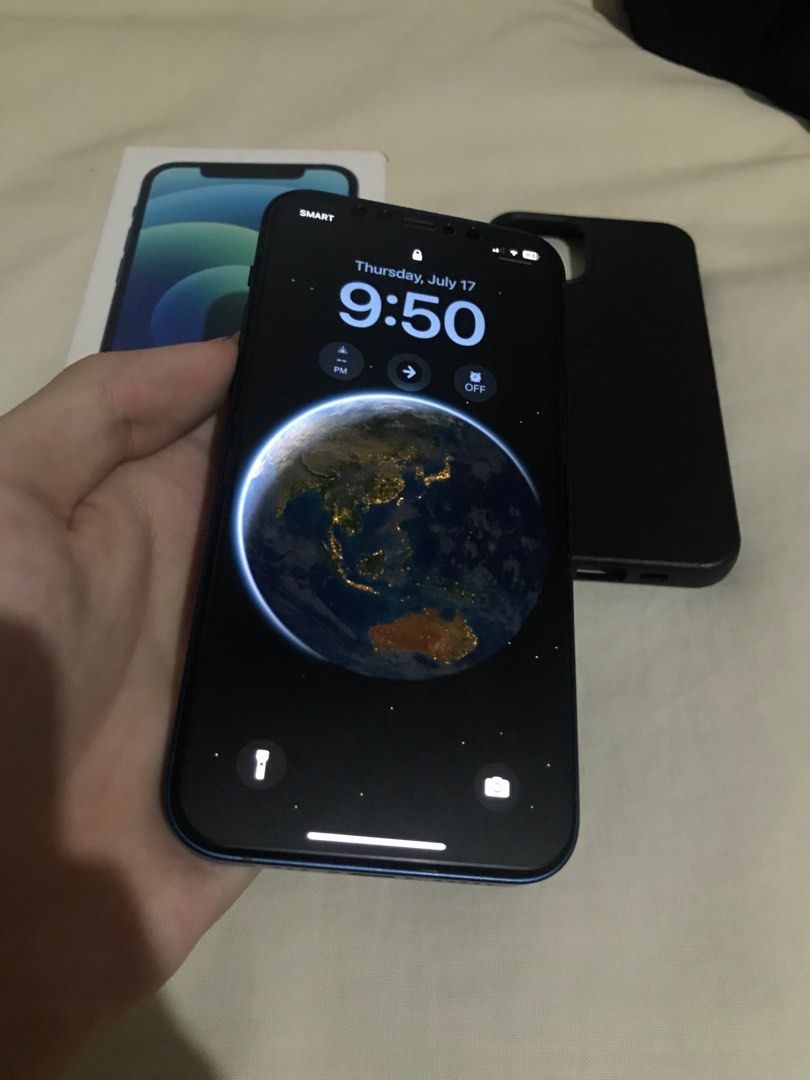 iPhone 12 128GB Midnight Blue Colorway (Category: iPhone 12 Series) located in Quezon City. Submitted by kaiven051921 (Listing ID 1381957326, Image 3). Description: iPhone 12 Midnight Blue Color 128GB Face ID Working True Tone Working Unli Reset Issue: Smart lock un lang Other than that sobrang kinis Comes with box case and ceramic tempered glass Location: Tandang sora QC.