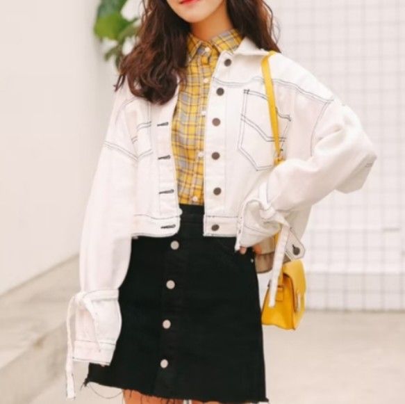 white denim crop spring jacket w/ ribbon tassels (Category: Coats, Jackets and Outerwear) located in Pasig City. Submitted by croisshark (Listing ID 1382214640, Image 2). Description: unique denim crop top with a slit back design. the silhouette has a dropped shoulder w/ puffy sleeves for a relaxed, slightly oversized but intentional coolgirl look. cute removeable bow tassels on the sleeves! contrast black stitching adds a pop of color would look