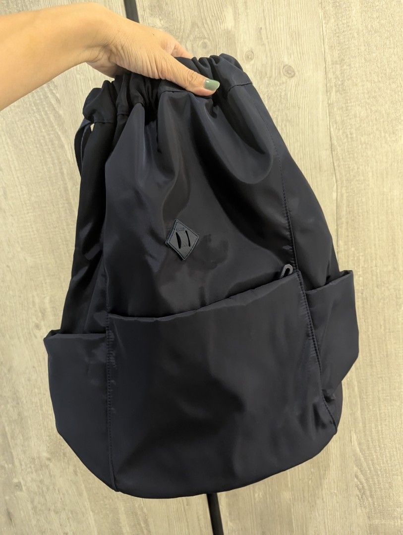 Drawstring backpack bag (Category: Backpacks) located in Singapore. Submitted by peasnbeansprouts (Listing ID 1382402963, Image 2). Description: drawstring backpack in Navy 43x15x30cm bought wrongly.