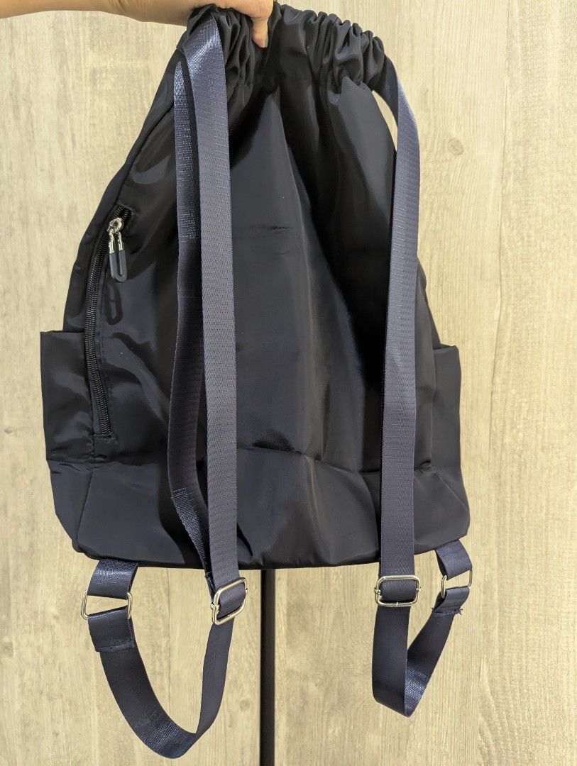 Drawstring backpack bag (Category: Backpacks) located in Singapore. Submitted by peasnbeansprouts (Listing ID 1382402963, Image 3). Description: drawstring backpack in Navy 43x15x30cm bought wrongly.