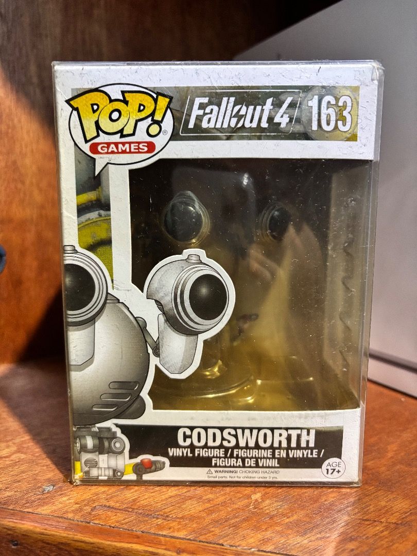 Funko Pop! Games - Fallout 4 Codsworth #163 (NIB, Minor Box Wear) (Category: Designer & Blind Box Toys) located in Imus. Submitted by ceeeentz (Listing ID 1382457488, Image 1). Description: For sale is an original Funko Pop! Games - Fallout 4 Codsworth #163 vinyl figure. 🛠️ Condition: Item is brand new and never removed from the box (NIB) Box has visible shelf wear (scratches on plastic window, minor corner dents) – see actual photo Great for Fa
