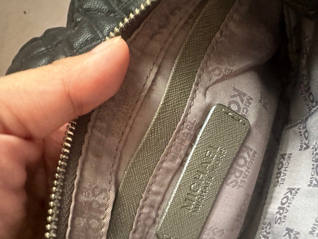 Michael kors pochette bag (Category: Luxury Bags & Wallets) located in Imus. Submitted by bunny_mei (Listing ID 1382337104, Image 3). Description: Mk monogram pochette bag Has a slight cracks in the handle and a red stain in the back (barely noticeable) .