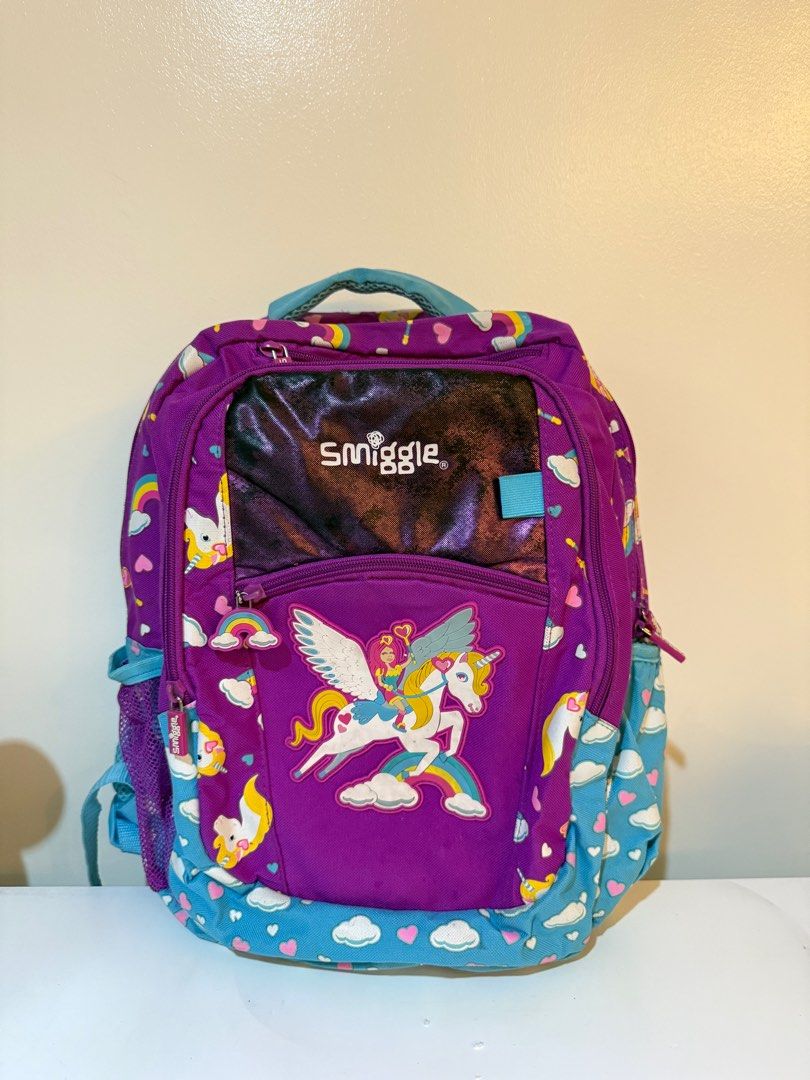 Original Smiggle Purple Unicorn Backpack (Category: Babies & Kids Fashion) located in Las Pinas. Submitted by slua19 (Listing ID 1382435794, Image 1). Description: SLIGHTLY NEGOTIABLE FOR SURE BUYERS - Bought in Smiggle SG for ₱4000+ - Slight damage in stitching in 2nd front pocket, other than that the bag is in very good condition - Chat for more pics :).