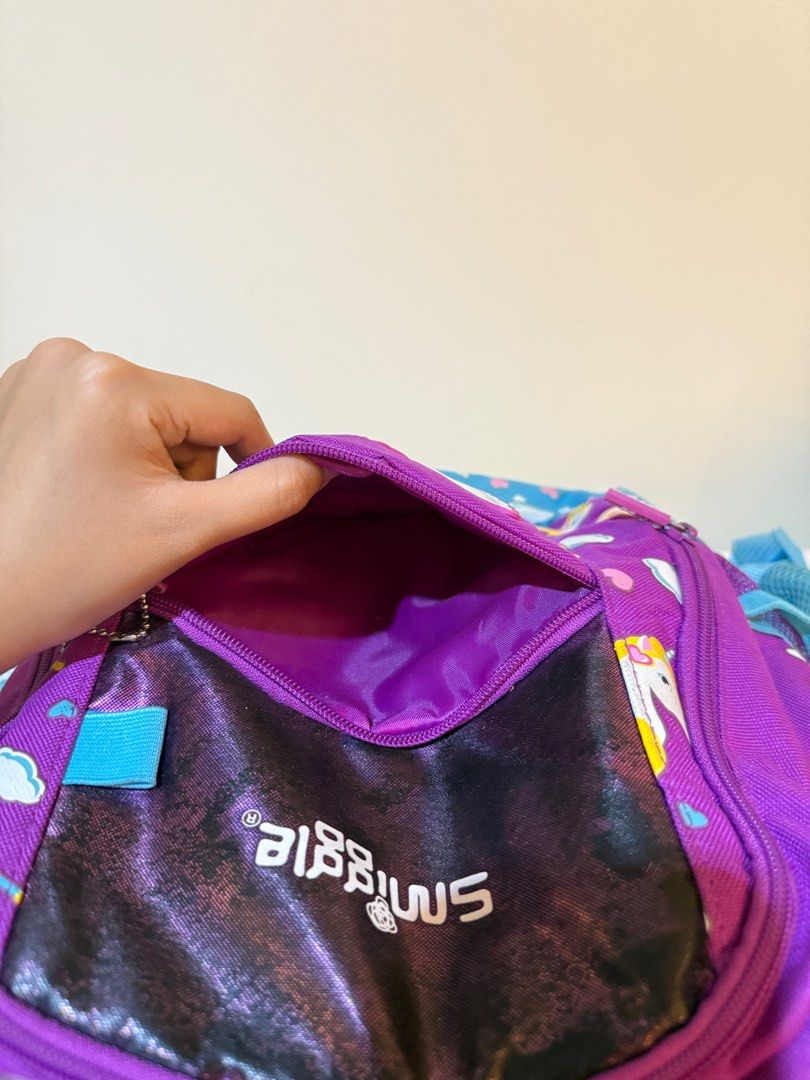 Original Smiggle Purple Unicorn Backpack (Category: Babies & Kids Fashion) located in Las Pinas. Submitted by slua19 (Listing ID 1382435794, Image 3). Description: SLIGHTLY NEGOTIABLE FOR SURE BUYERS - Bought in Smiggle SG for ₱4000+ - Slight damage in stitching in 2nd front pocket, other than that the bag is in very good condition - Chat for more pics :).