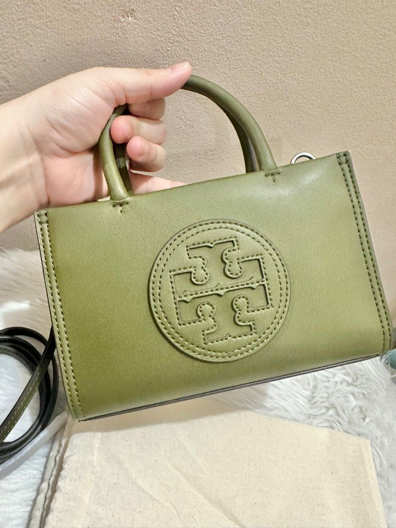 Original Tory Burch Ella Bio mini tote green Leather (Category: Luxury Bags & Wallets) located in Las Pinas. Submitted by anasonlineshophtplaspinas (Listing ID 1382455639, Image 3). Description: Original Tory Burch Ella Bio mini tote green Leather Faux leather item Two rigid handles Magnetic fastening Internal flat pocket Adjustable and removable leather shoulder strap Silver-tone metal hardware Herringbone fabric lining Width: 18,5 cm Height: 12