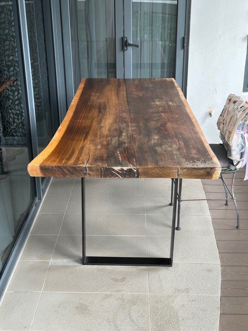 Solid Wood Dining Table (Category: Tables & Sets) located in Singapore. Submitted by carameldanse (Listing ID 1382374343, Image 3). Description: Solid wood dining table, in great condition, tabletop just needs sanding and repolishing. 200 cm length by 85 cm width, 80 cm tall. Legs are made of iron and detachable. Please arrange for self-collection..