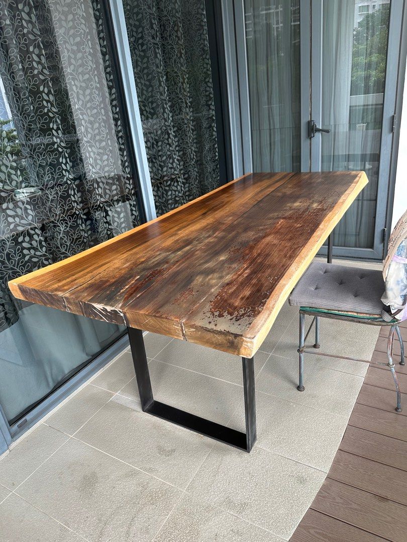 Solid Wood Dining Table (Category: Tables & Sets) located in Singapore. Submitted by carameldanse (Listing ID 1382374343, Image 1). Description: Solid wood dining table, in great condition, tabletop just needs sanding and repolishing. 200 cm length by 85 cm width, 80 cm tall. Legs are made of iron and detachable. Please arrange for self-collection..