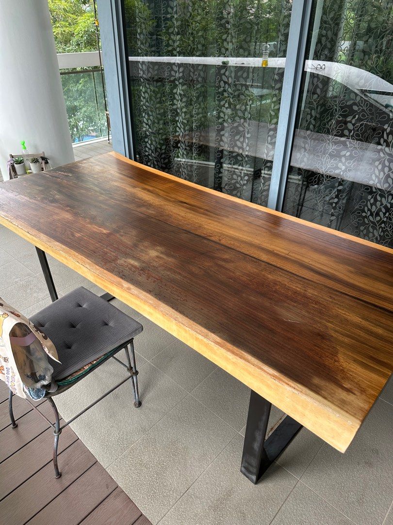 Solid Wood Dining Table (Category: Tables & Sets) located in Singapore. Submitted by carameldanse (Listing ID 1382374343, Image 2). Description: Solid wood dining table, in great condition, tabletop just needs sanding and repolishing. 200 cm length by 85 cm width, 80 cm tall. Legs are made of iron and detachable. Please arrange for self-collection..