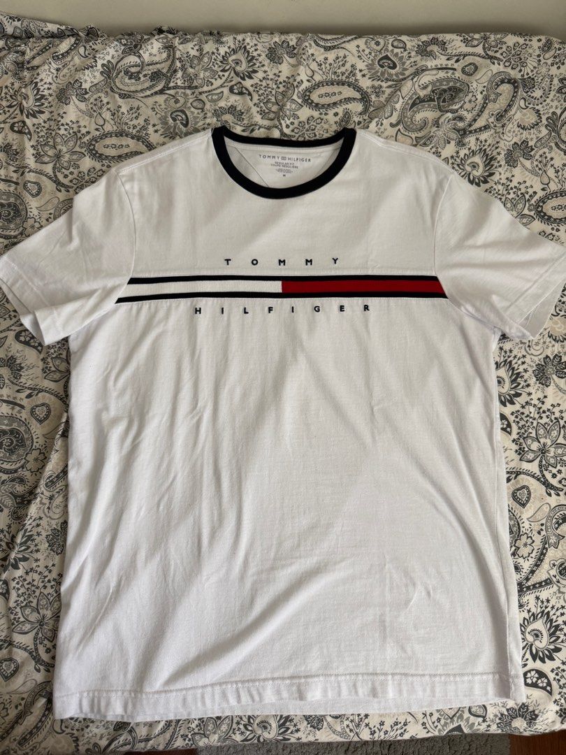Tommy Hilfiger Shirt Medium White (Category: Tshirts & Polo Shirts ) located in Baliuag. Submitted by jaredcarousel (Listing ID 1382323777, Image 1). Description: Tommy Hilfiger Shirt White / Navy Logo Embroidered Size: Medium 999 + SF Used once only. RFS: Decluttering.