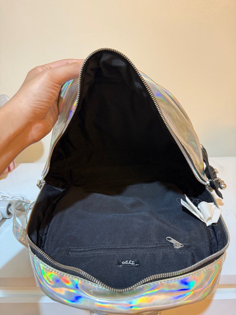 Typo Holographic Backpack (Category: Backpacks) located in Las Pinas. Submitted by slua19 (Listing ID 1382420846, Image 3). Description: SLIGHTLY NEGOTIABLE FOR SURE BUYERS - Bought in Typo Greenbelt store for ₱1000+ - Chat for more pics :).