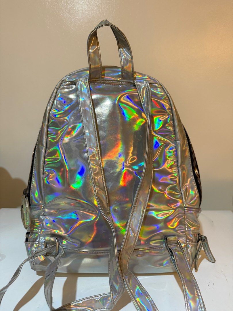 Typo Holographic Backpack (Category: Backpacks) located in Las Pinas. Submitted by slua19 (Listing ID 1382420846, Image 2). Description: SLIGHTLY NEGOTIABLE FOR SURE BUYERS - Bought in Typo Greenbelt store for ₱1000+ - Chat for more pics :).