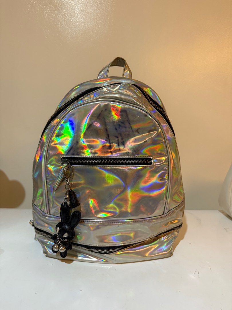 Typo Holographic Backpack (Category: Backpacks) located in Las Pinas. Submitted by slua19 (Listing ID 1382420846, Image 1). Description: SLIGHTLY NEGOTIABLE FOR SURE BUYERS - Bought in Typo Greenbelt store for ₱1000+ - Chat for more pics :).
