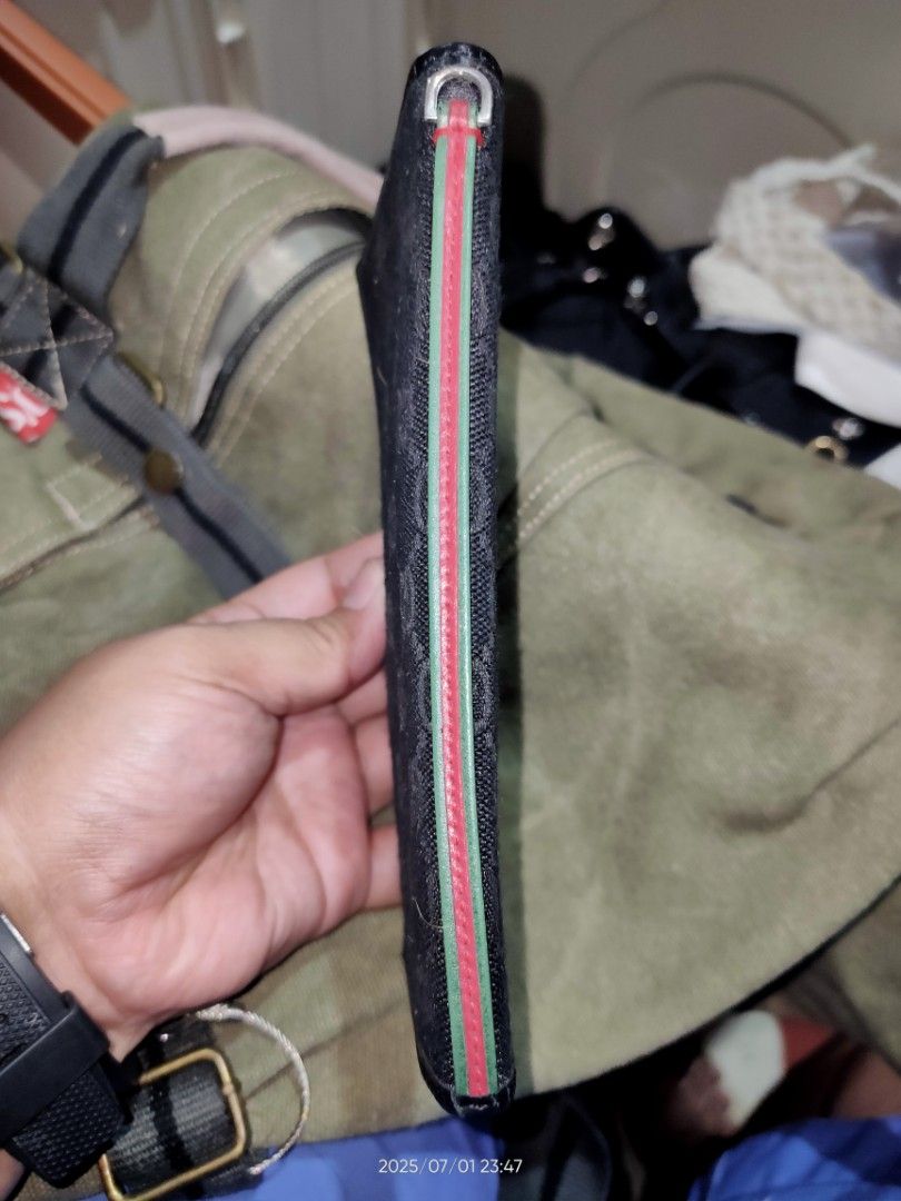 Gucci slim wallet (Category: Luxury Bags & Wallets) located in Los Banos. Submitted by tritrollse.04 (Listing ID 1382769149, Image 3). Description: Still in good condition Canvas with minimum signs of Usage bought it from cousin who lives in Japan when she visited for 3500 no inclusions Coded Bifold style, featuring the brand's iconic GG monogram pattern in black canvas with a distinctive red and green "Web" stripe down the center. Payment First 