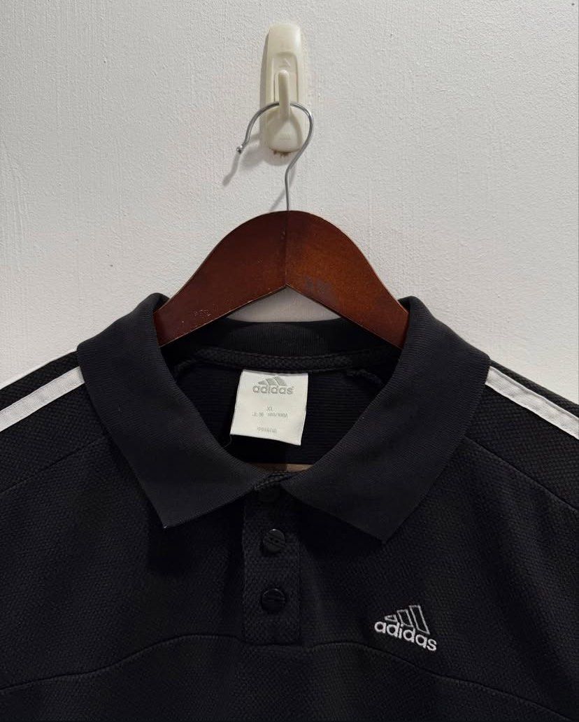 Adidas Three Stripes polo shirt (Category: Activewear) located in Calamba. Submitted by le.fleurrr_ (Listing ID 1383060230, Image 3). Description: Adidas Three Stripes Polo Shirt - size: XL but fits large (semi-cropped fit) - width: 22 - length: 26 - sleeves: 9 - color rate: 8.5/10 “only issue is Minor fading — adds a vintage look, overall in good condition” Price: ₱280 only 📍Calamba .