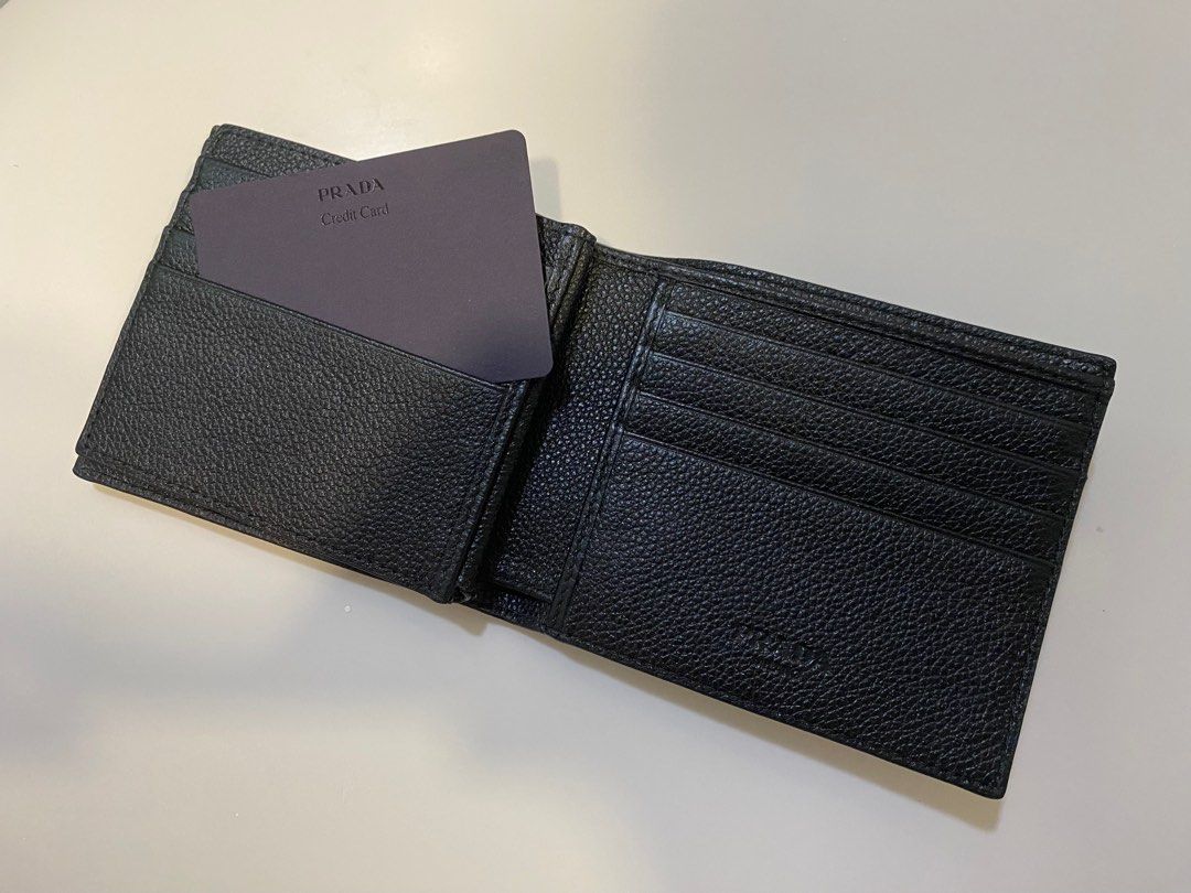 Prada Black Leather Wallet (Category: Bags & Wallets) located in Singapore. Submitted by bryant_kobe1 (Listing ID 1382913709, Image 2). Description: Made of black leather with the Prada logo on the front. Features multiple card slots and a bill compartment. Includes a Prada credit card. A stylish and practical accessory. Meet up’s can be discussed Urgent!! *DOES NOT COME WITH DUST BAG OR BOX* 💯%Authentic (Will let you inspect before meet up).