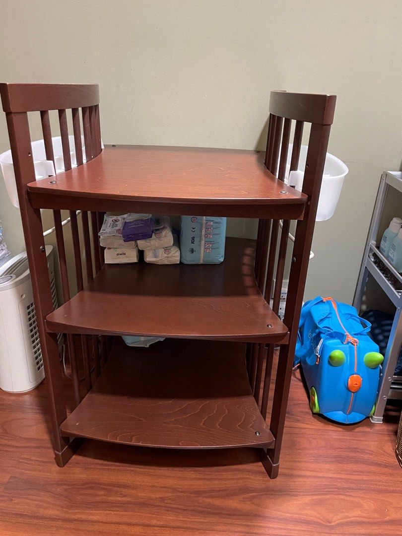 Stokke Changing Table (Category: Changing Tables & Stations) located in Kuala Lumpur. Submitted by deepa8912 (Listing ID 1382953441, Image 2). Description: Solid wood and premium changing table in walnut colour. 2 sides baskets to place wipes, lotions, creams and 2 rows below to store diapers. .