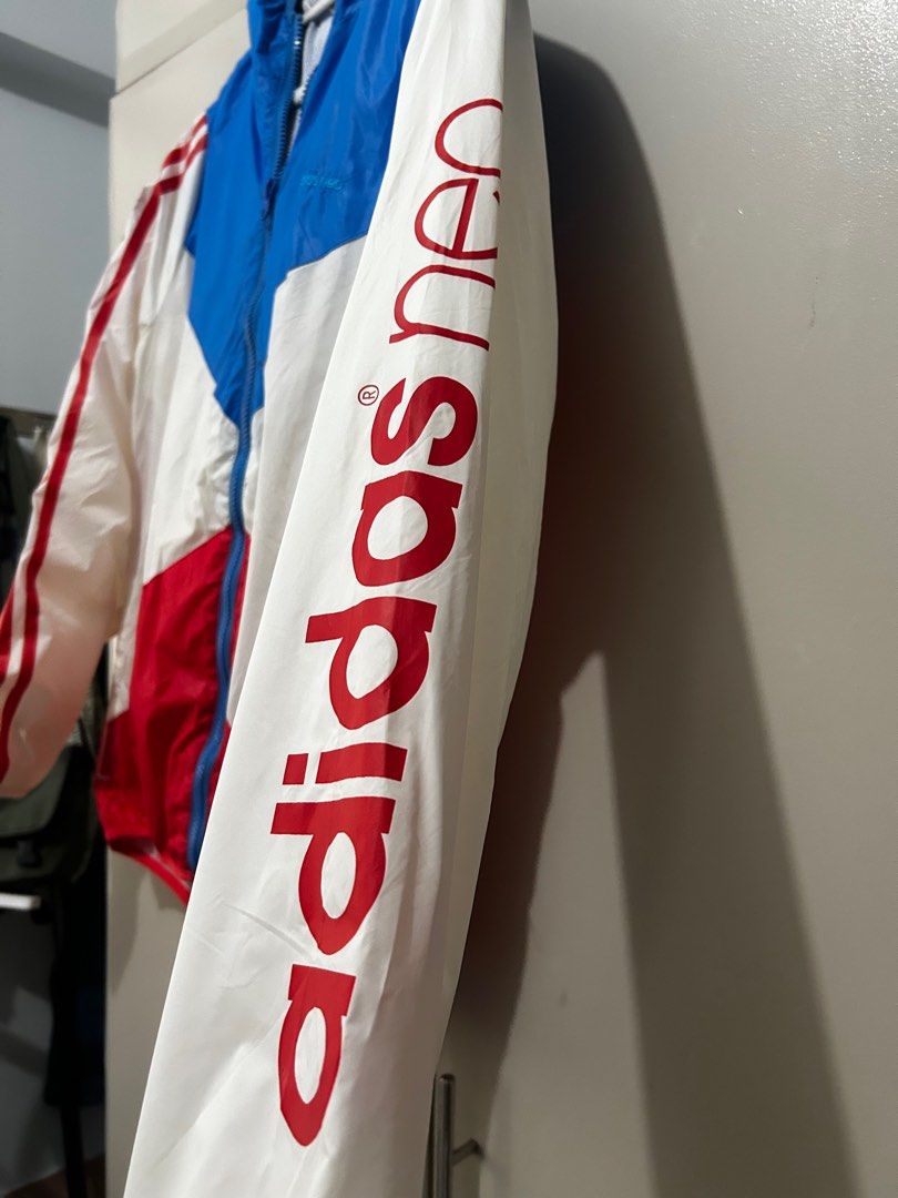 Adidas Neo Windbreaker jacket (white, blue, red) (Category: Coats, Jackets and Outerwear) located in Taguig. Submitted by declutteringbyjulia (Listing ID 1383073833, Image 3). Description: Windbreaker in red, white, and blue colorway Medium to Large frame 5'8" model .