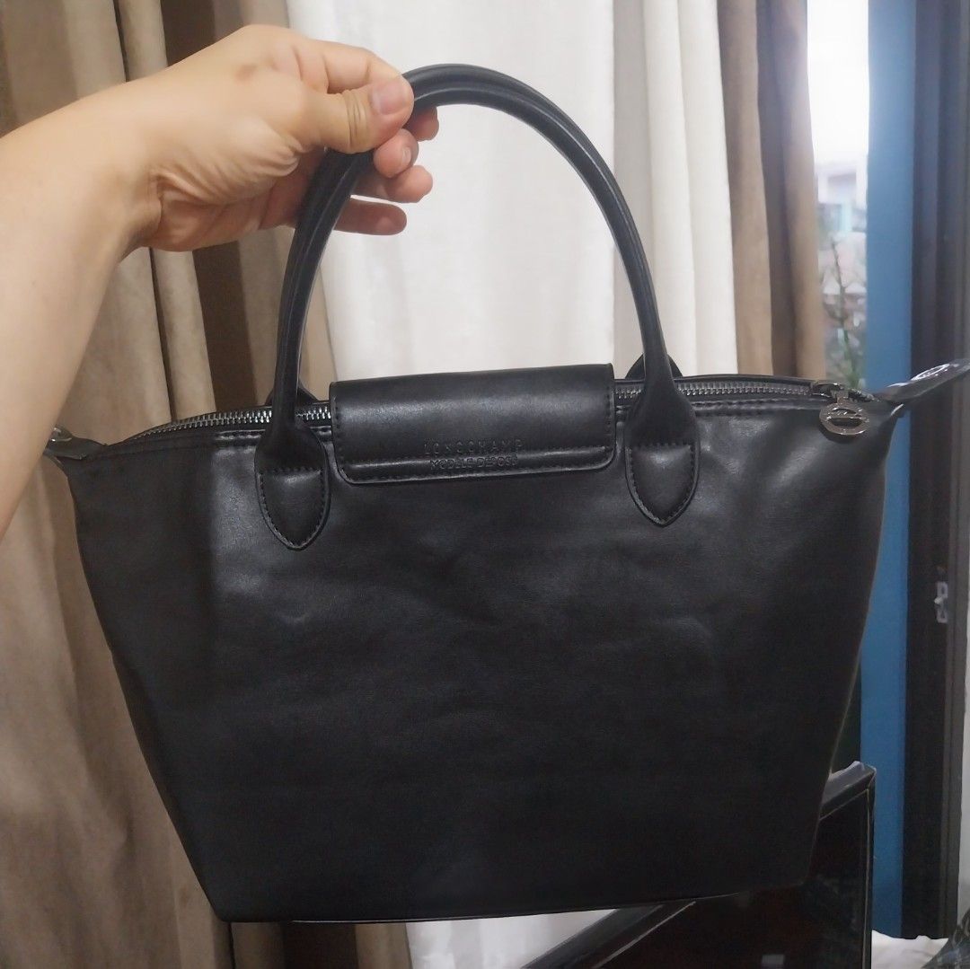 LONGCHAMP Hand/Shoulder Bag (Category: Shoulder Bags) located in Quezon City. Submitted by jonvee2000 (Listing ID 1383181713, Image 2). Description: Preloved with leather strap Lamb skin No rubs/issues ykk zipped soft leather sign of usage only Measurement: H = 9 inches L = 11 expandable to 15 inches W = 4.5 inches Color = Black.