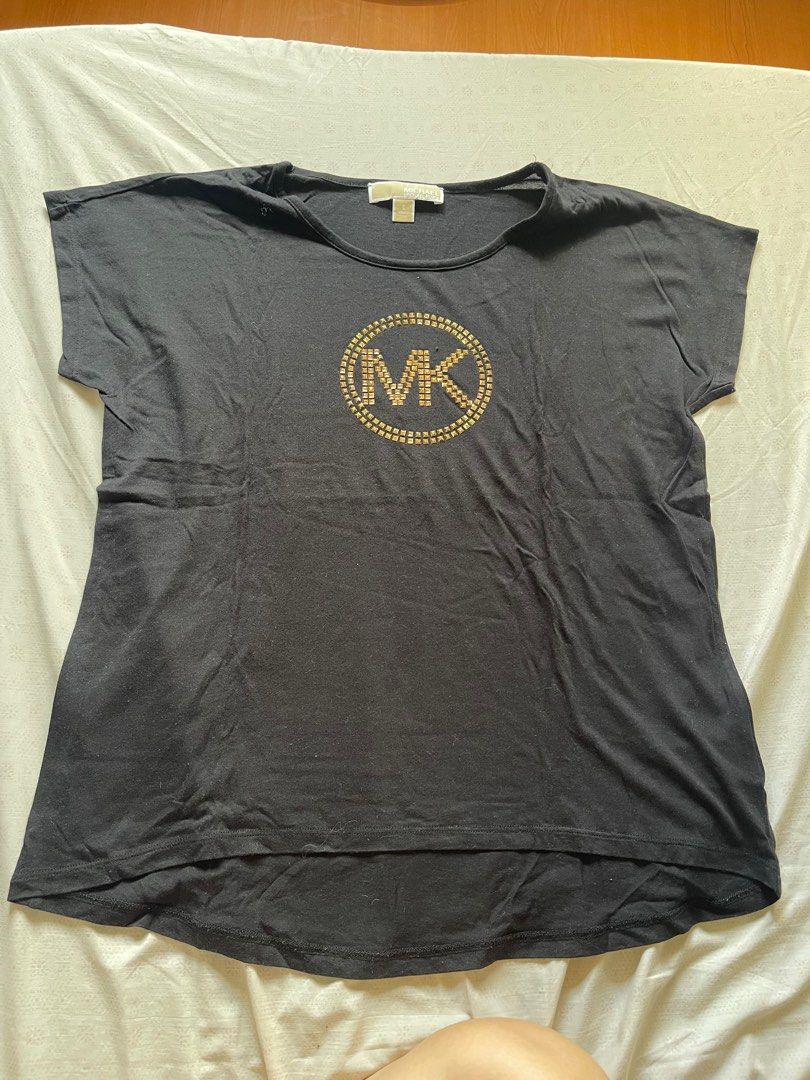 Authentic Michael Kors T-shirt (Category: Shirts) located in Quezon City. Submitted by RoxyB (Listing ID 1383312083, Image 1). Description: Preloved MK black t-shirt. Fits S-M. In very good condition. Used twice only. RFS: Decluttering .