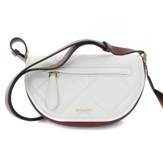 Burberry Bag (Category: Luxury Bags & Wallets) located in Baguio. Submitted by thrift_saver07 (Listing ID 1383324994, Image 1). Description: White Burberry Small Olympia Shoulder Bag PRODUCT DETAILS: White Burberry Small Olympia Shoulder Bag. The Olympia features a quilted leather body, a flat leather shoulder strap, a flap with magnetic snap closure, and an exterior front zip pocket. 4.9" L x 7.1" W x 1.6" D. Condition: Pre-Owned. Signs of usage