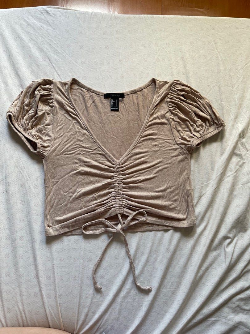 Forever 21 beige/nude top with adjustable string (Category: Others Tops) located in Quezon City. Submitted by RoxyB (Listing ID 1383295942, Image 1). Description: Preloved Forever 21 nude color top with adjustable string. This can be turned into a crop top when strings are adjusted. Fits XS-S RFS: Decluttering .
