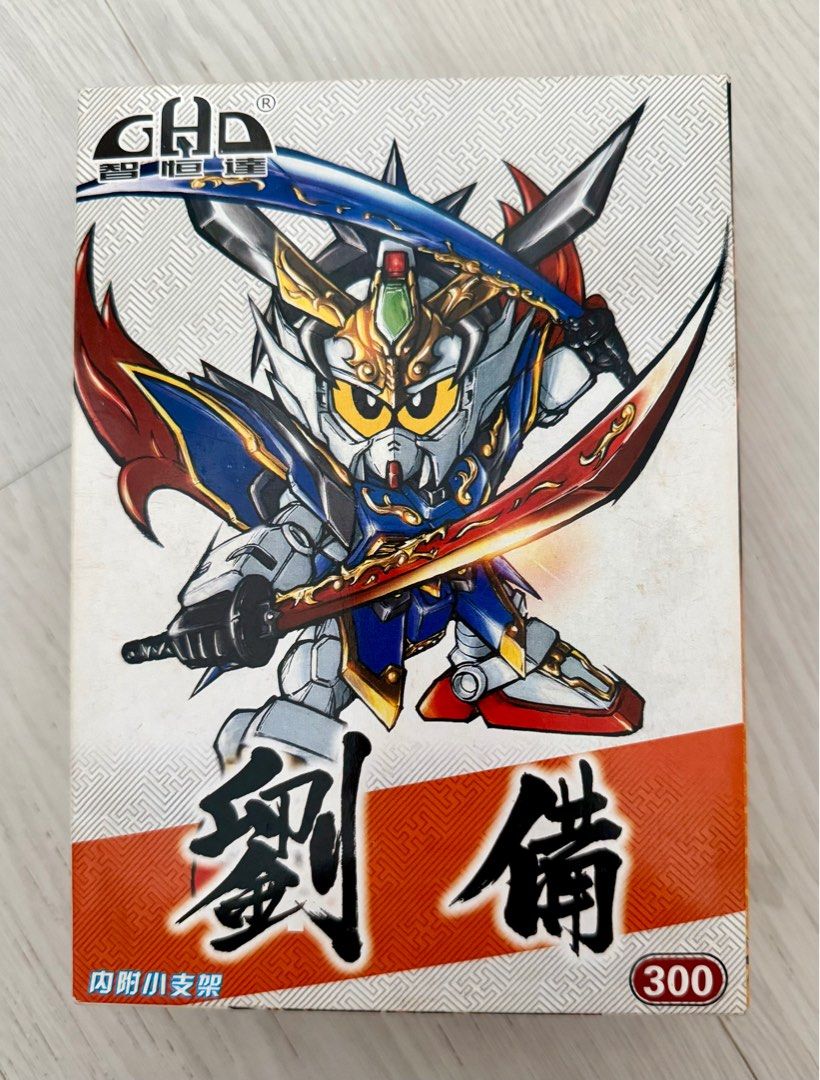 GHD SD Gundam Model Kit (Category: Gundam Model Kits) located in Singapore. Submitted by calveeno (Listing ID 1383369218, Image 1). Description: - GHD SD Gundam model kit - Samurai-themed design - Features multiple swords - 300 series model - Includes original box - Unassembled.