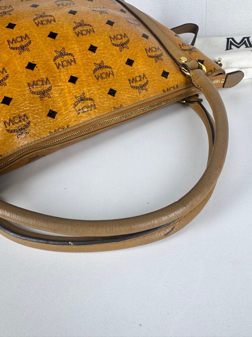 [Authentic] MCM cognac visetos leather (Category: Luxury Bags & Wallets) located in Tabuk. Submitted by meksieclosetph (Listing ID 1383545432, Image 3). Description: Authentic MCM Cognac Visetos Leather 2-Way Bag 💼 Condition: Preloved – Excellent, ✔️ 100% Authentic ✔️ Comes with authenticity card, dust bag, and detachable sling strap ✔️ Minimal signs of use - DM for more details. ✨ Details: • Signature MCM Visetos coated canvas in iconic cognac 