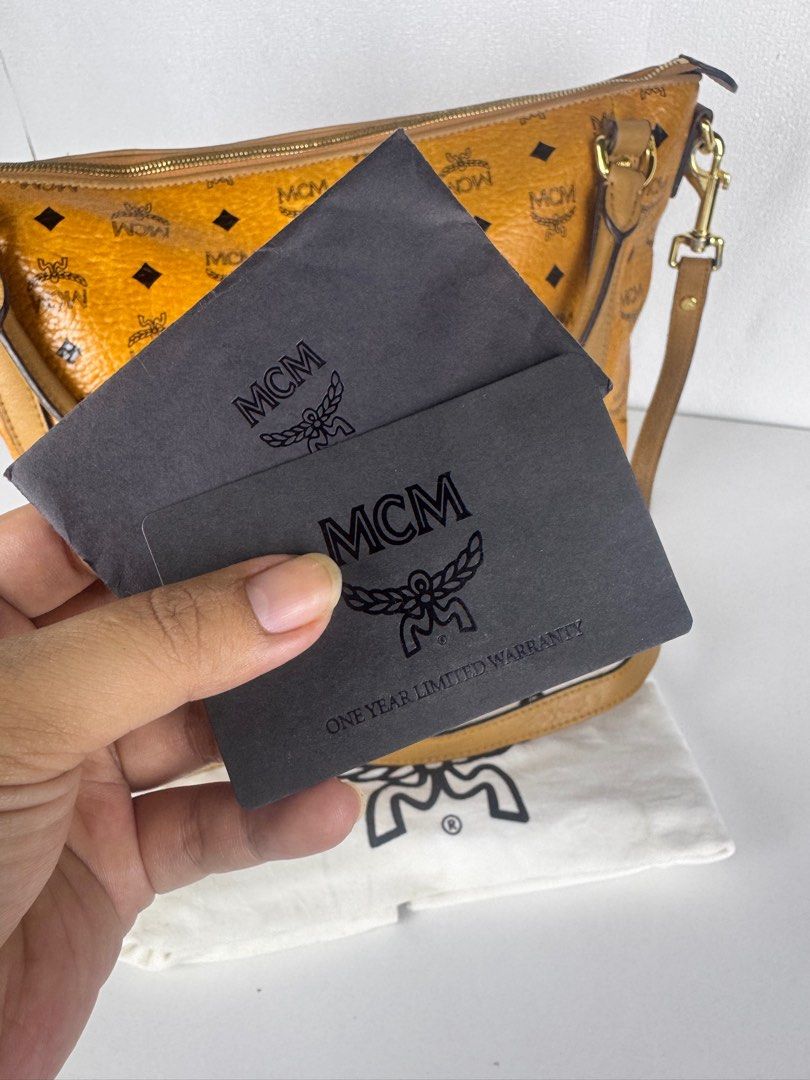 [Authentic] MCM cognac visetos leather (Category: Luxury Bags & Wallets) located in Tabuk. Submitted by meksieclosetph (Listing ID 1383545432, Image 2). Description: Authentic MCM Cognac Visetos Leather 2-Way Bag 💼 Condition: Preloved – Excellent, ✔️ 100% Authentic ✔️ Comes with authenticity card, dust bag, and detachable sling strap ✔️ Minimal signs of use - DM for more details. ✨ Details: • Signature MCM Visetos coated canvas in iconic cognac 