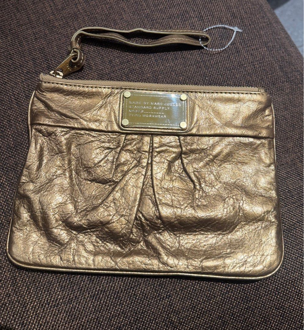 Marc Jacobs Wristlet (Category: Luxury Bags & Wallets) located in Bacolod City. Submitted by charmvault (Listing ID 1383545892, Image 1). Description: 📌Marc Jacobs Wristlet in Metallic Gold •US Bought🇺🇸 •Orig💯 •Genuine Leather •Preloved item | In Excellent condition •Can fit iphone pro max, card or coin wallet and small stuffs •Pass sa barat!!! 🏷️₱1200 last price + SF c/o Buyer.