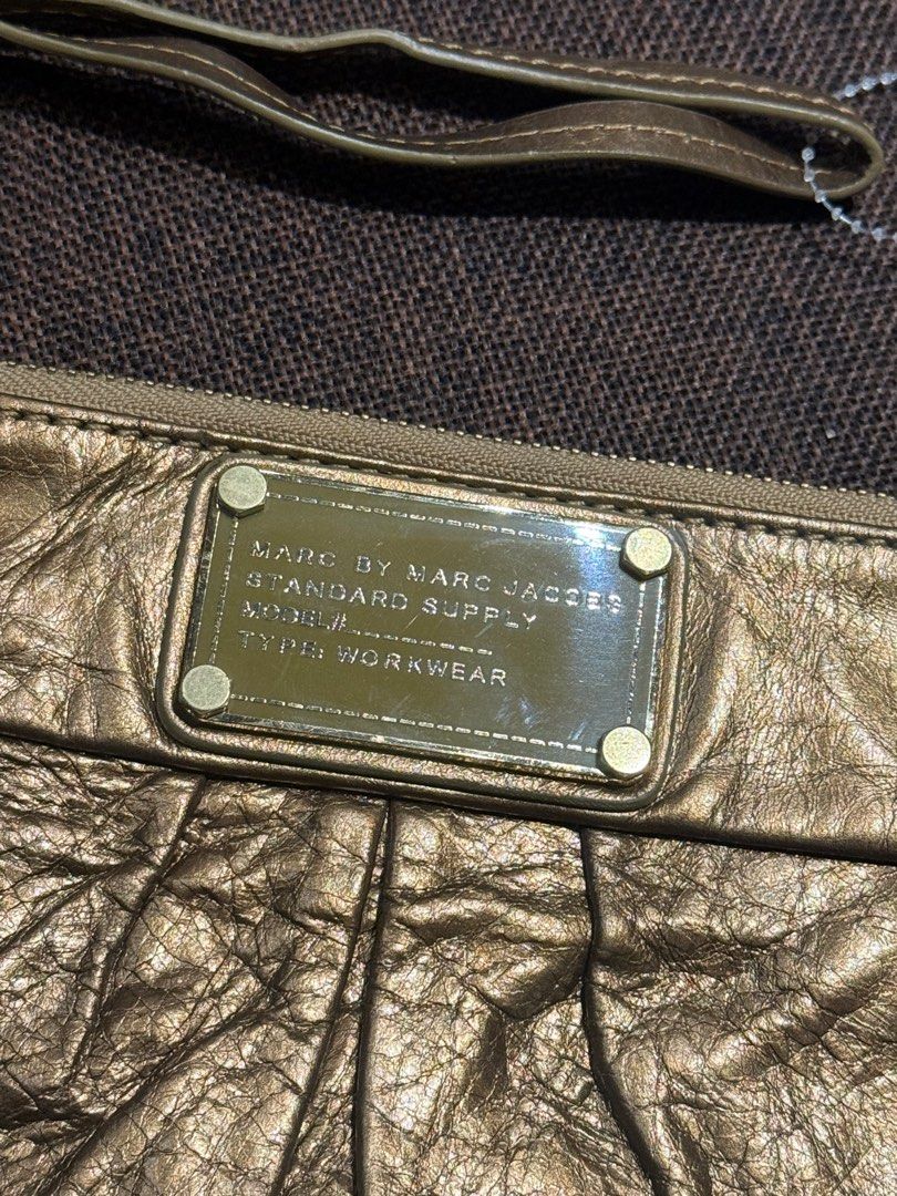 Marc Jacobs Wristlet (Category: Luxury Bags & Wallets) located in Bacolod City. Submitted by charmvault (Listing ID 1383545892, Image 2). Description: 📌Marc Jacobs Wristlet in Metallic Gold •US Bought🇺🇸 •Orig💯 •Genuine Leather •Preloved item | In Excellent condition •Can fit iphone pro max, card or coin wallet and small stuffs •Pass sa barat!!! 🏷️₱1200 last price + SF c/o Buyer.