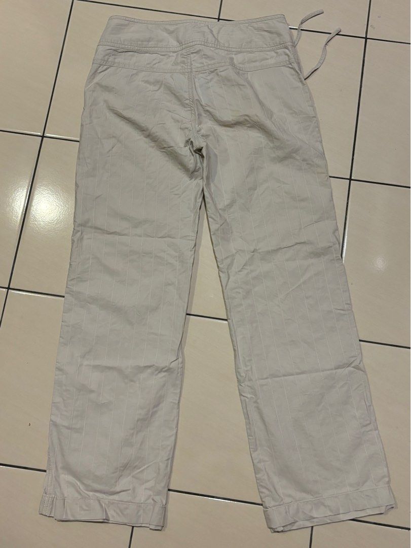 Y2K vintage buckle cream beige trousers pants (Category: Other Bottoms) located in Kuala Lumpur. Submitted by teachmehowtodougie (Listing ID 1383599504, Image 3). Description: -Thrifted but not my style hence selling -Size 28 on tag, true to size -Mid rise -Hemmed but the extra length is tucked under so if you’re taller can just undo the stitches -Open to negotiation, dm for any questions or details!!.