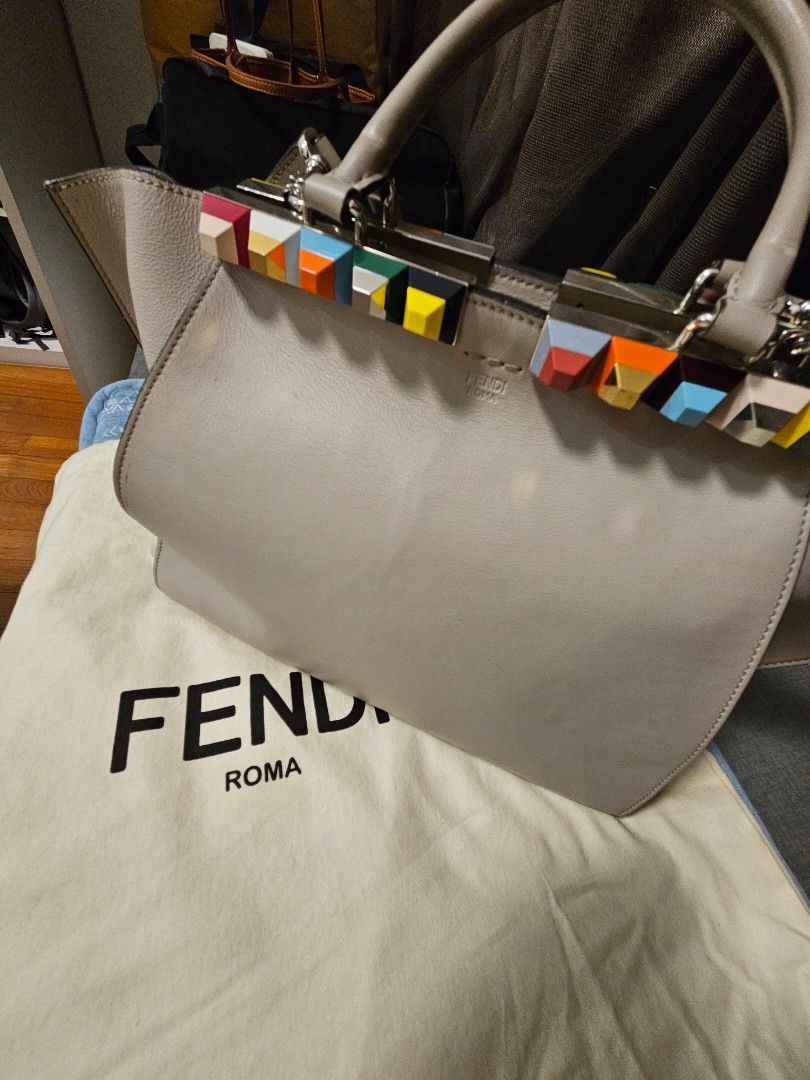 Fendi Peekaboo Handbag with Colorful Details (Category: Bags & Wallets) located in Singapore. Submitted by joseph1515 (Listing ID 1378366326, Image 1). Description: - Authentic Fendi Peekaboo handbag - Light grey leather exterior - Features colorful accents on the handle - Includes dust bag - Adds a pop of color to any outfit - Stylish and unique.