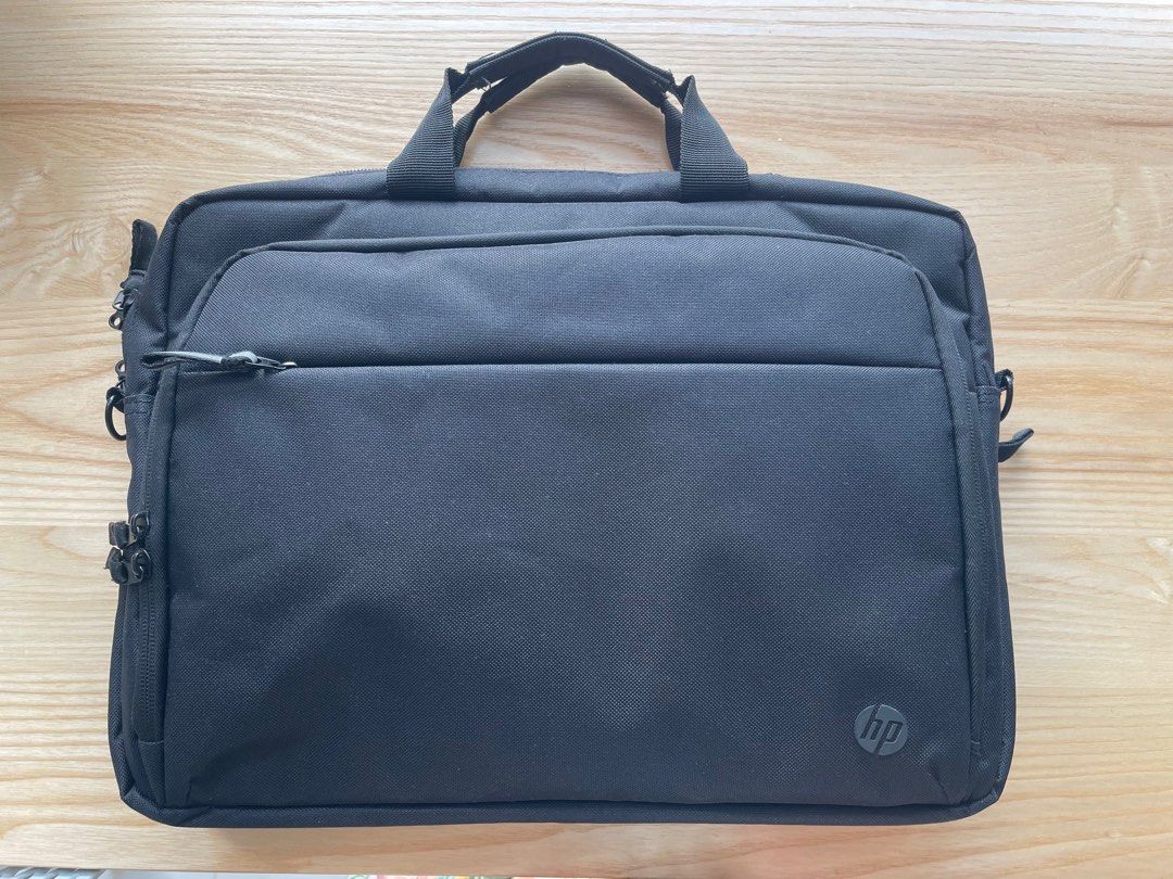HP Black Laptop Bag (Category: Laptop Bags & Sleeves) located in Singapore. Submitted by minglic (Listing ID 1378428050, Image 1). Description: Black HP laptop bag in excellent condition. Features multiple compartments and a handle. Protect your laptop and essentials..